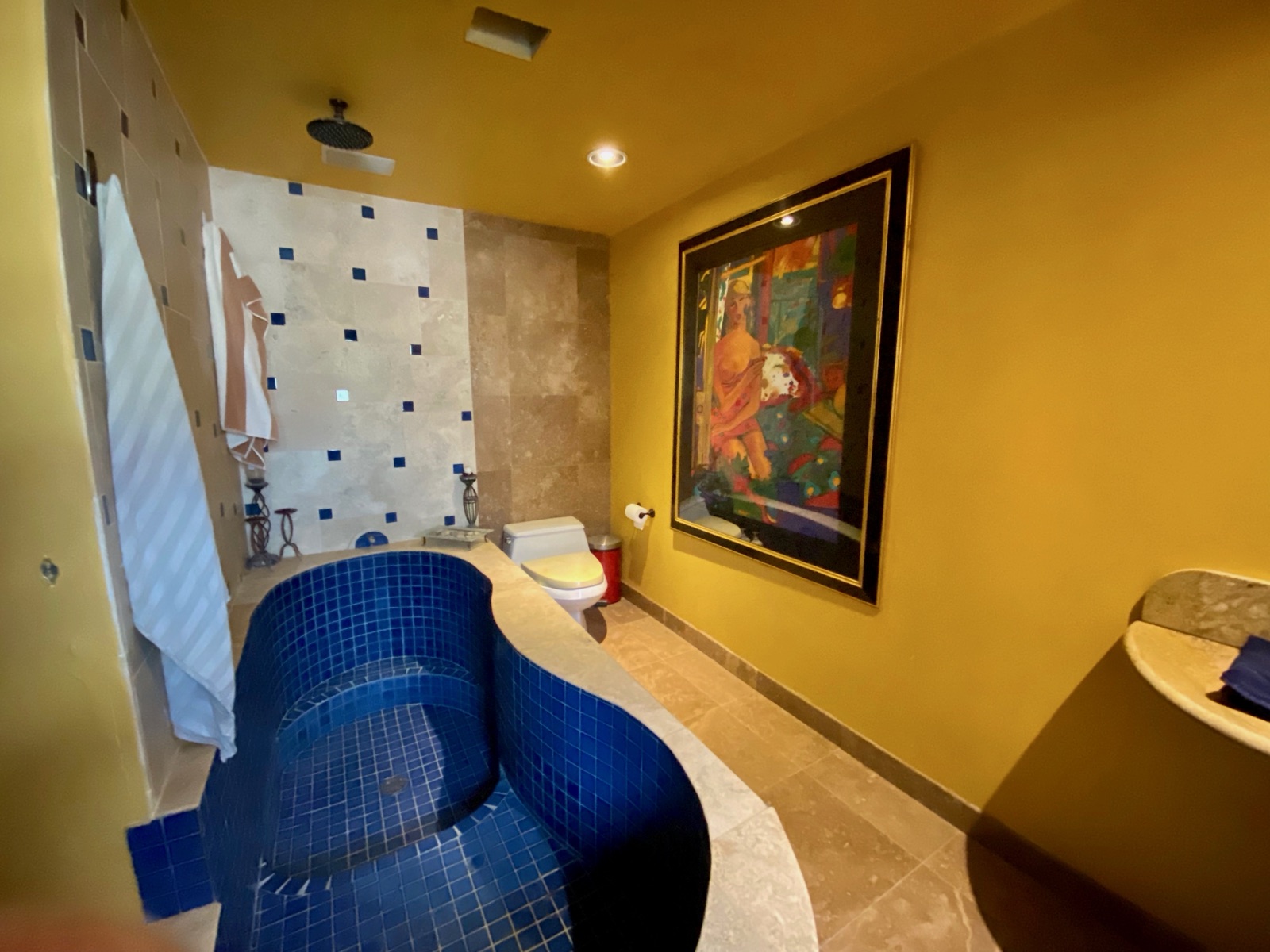 Spa bath with blue mosaic and walk-in shower